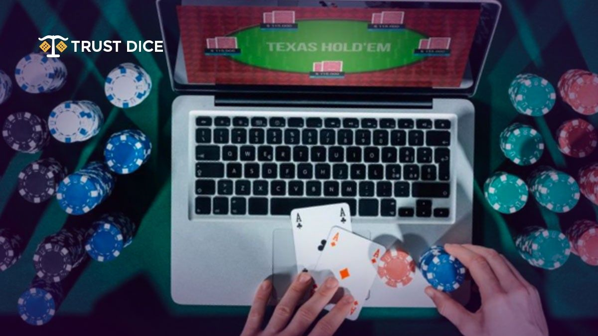 Playing Texas Hold 'em on laptop with casino chips