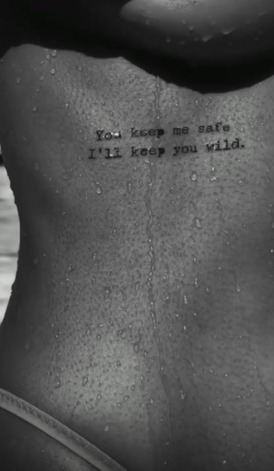 quote tattoo on woman's back