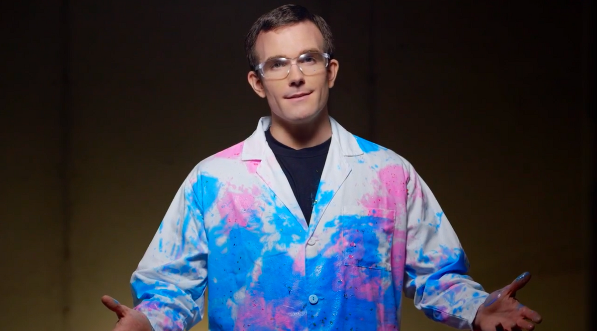 Man in a robe soiled with blue and pink paint
