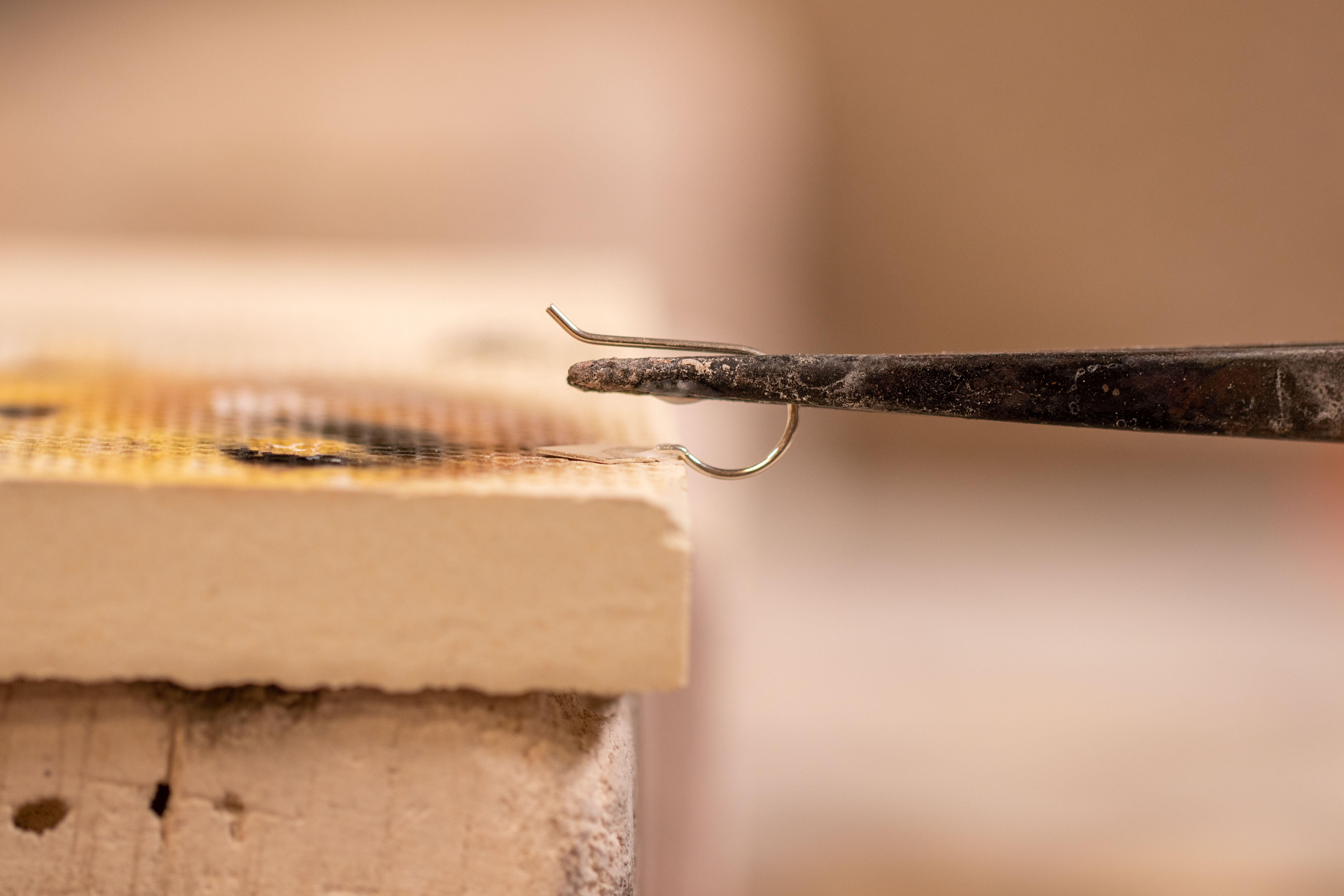 Ear Hook in cross locking tweezers set up to be soldered