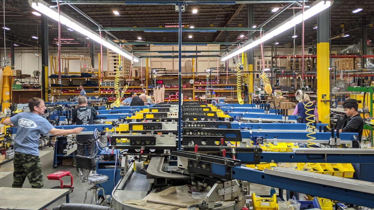 Workers building a screen printing press at M&R