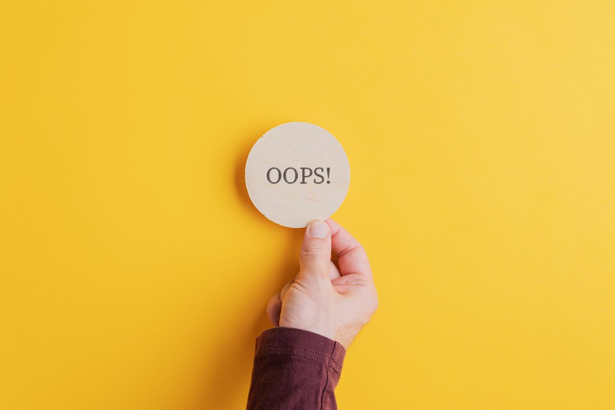Person holding up an "oops" sign because they missed a Medicare enrollment window