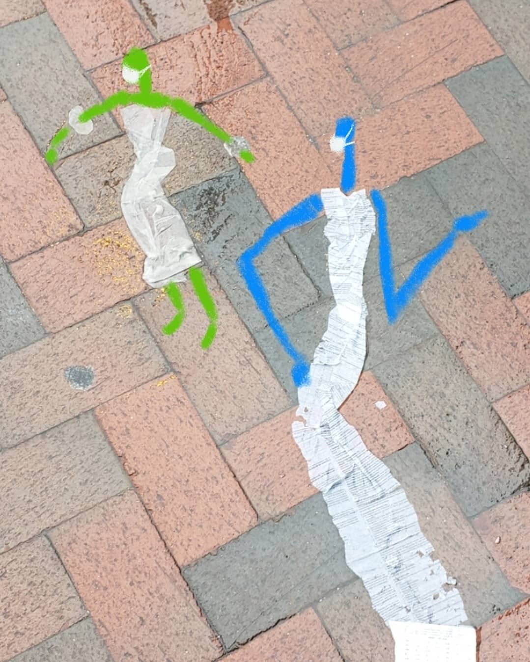 trash on ground with drawing to make them look like dresses