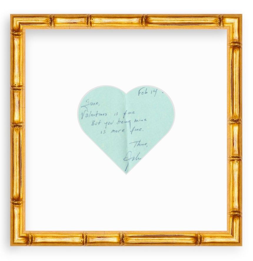 gold frame with heart-shaped mat and photo of note