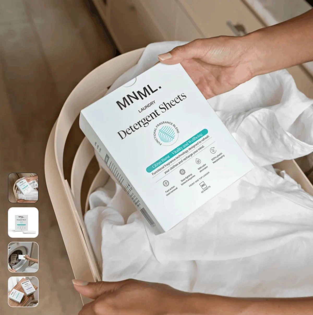 A hand is shown holding MNML Laundry detergent sheets in a box above some white fabric in a laundry basket.
