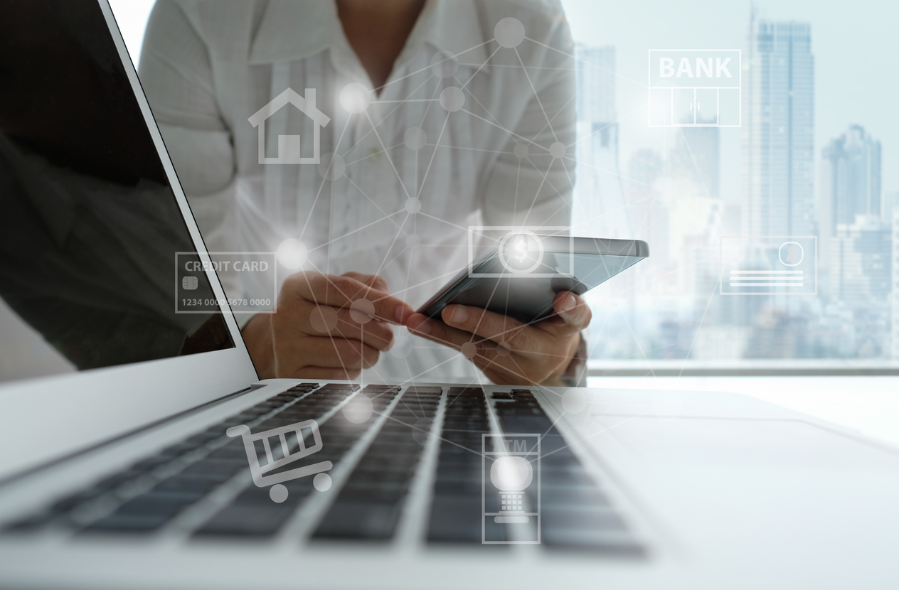 Person on phone by laptop