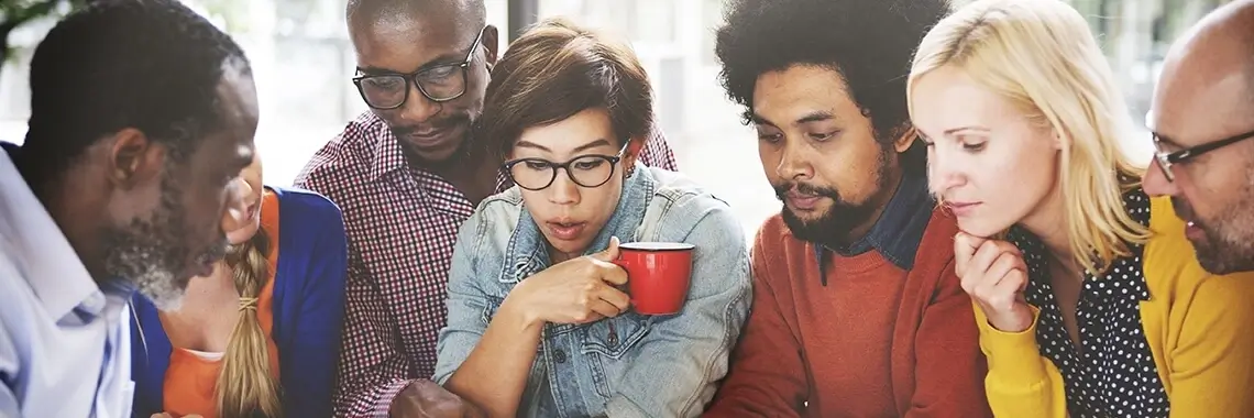 A group of people discussing something over coffee.