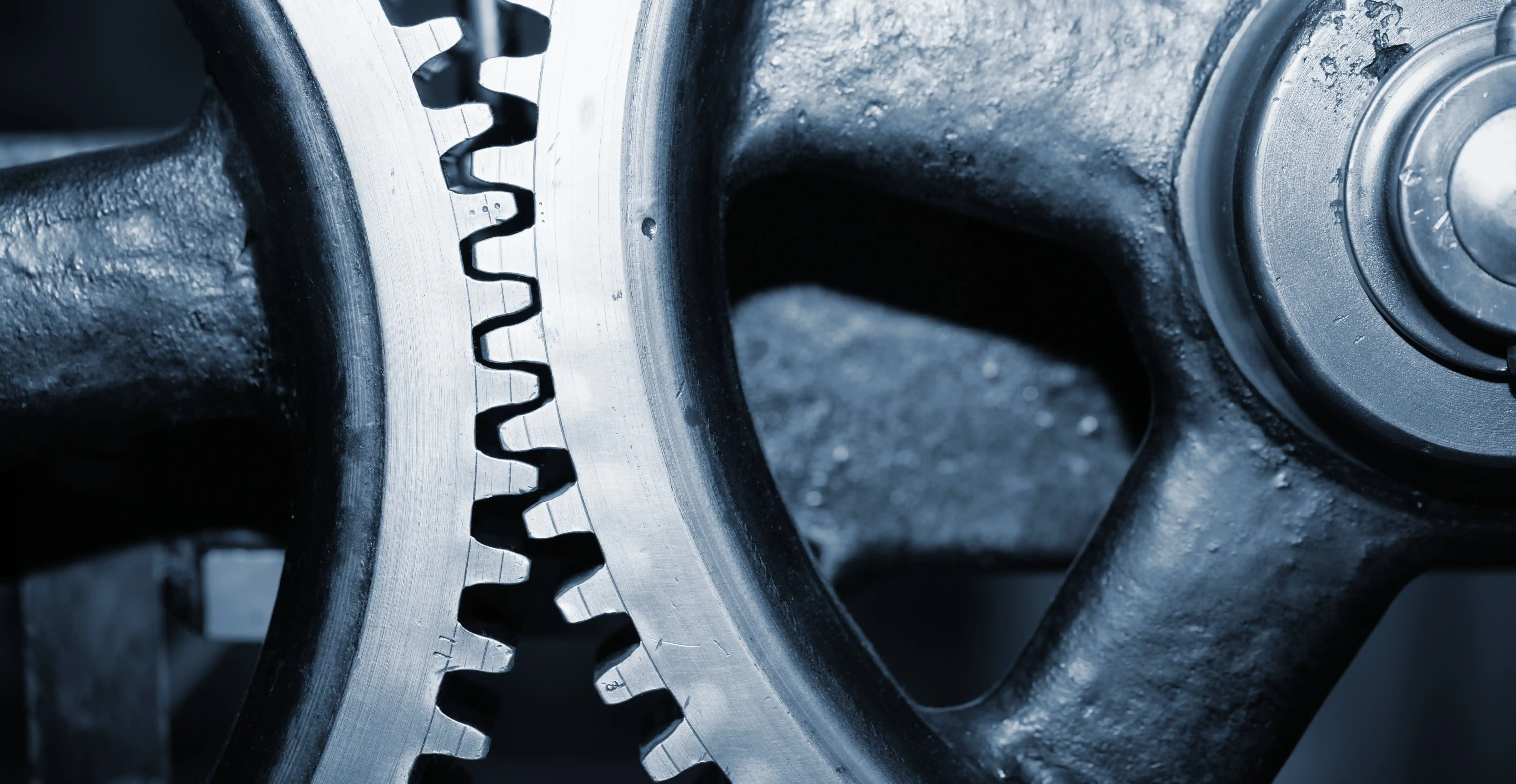 Close-up of interlocking gear wheels representing seamless operational synergy through cultural alignment