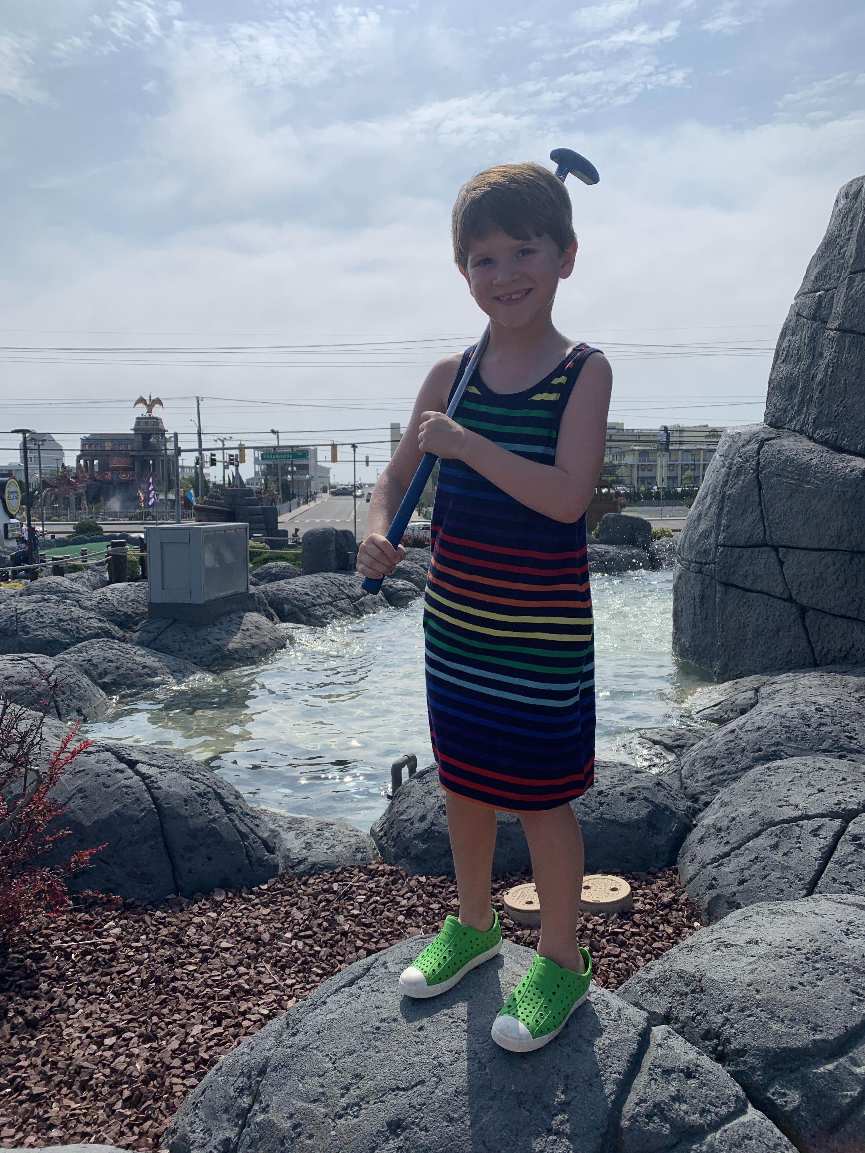 6 year old boy in sleeveless rainbow stripe tank top dress from primary