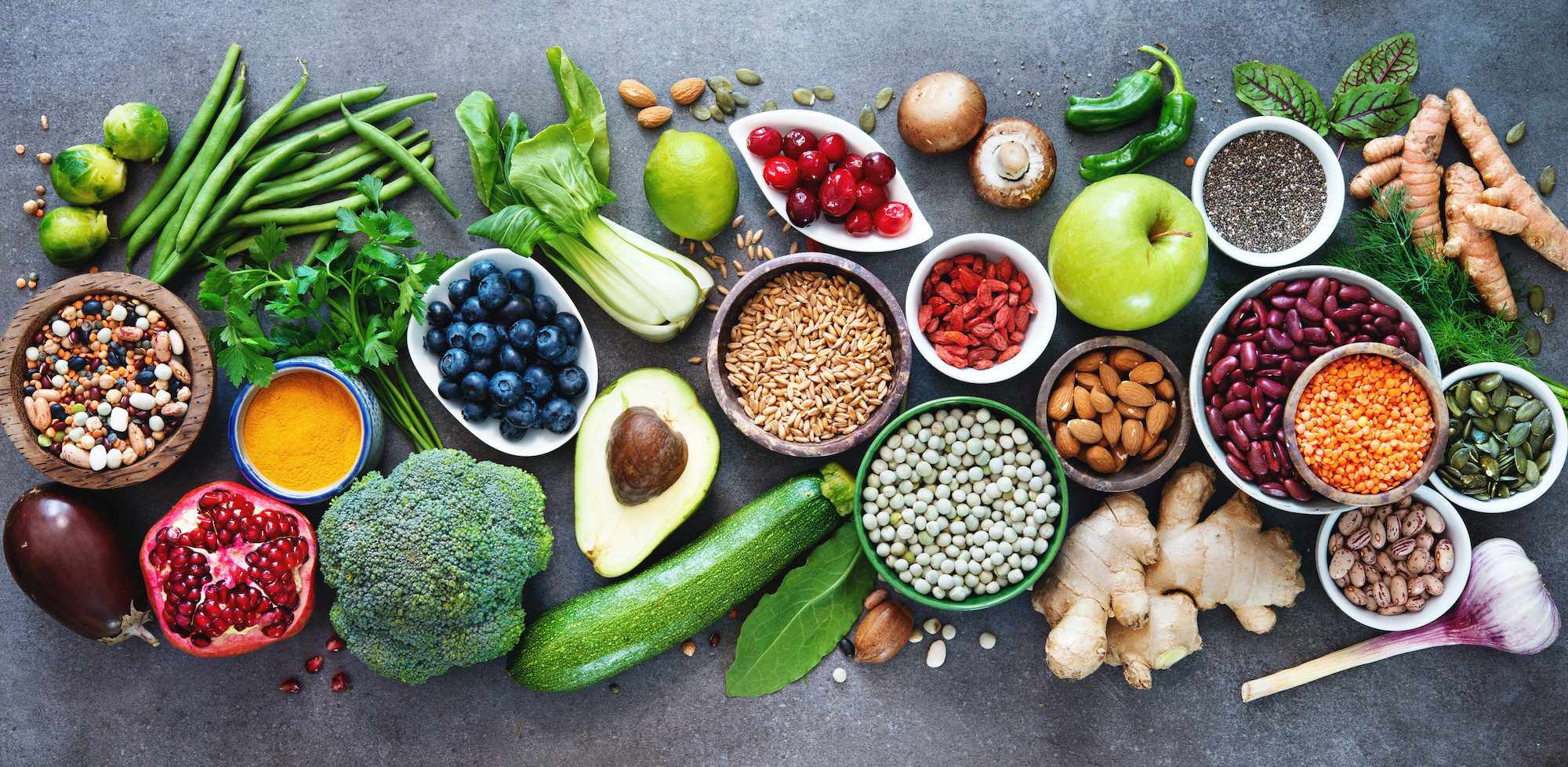 A collection of fruit, vegetables, nuts, and beans