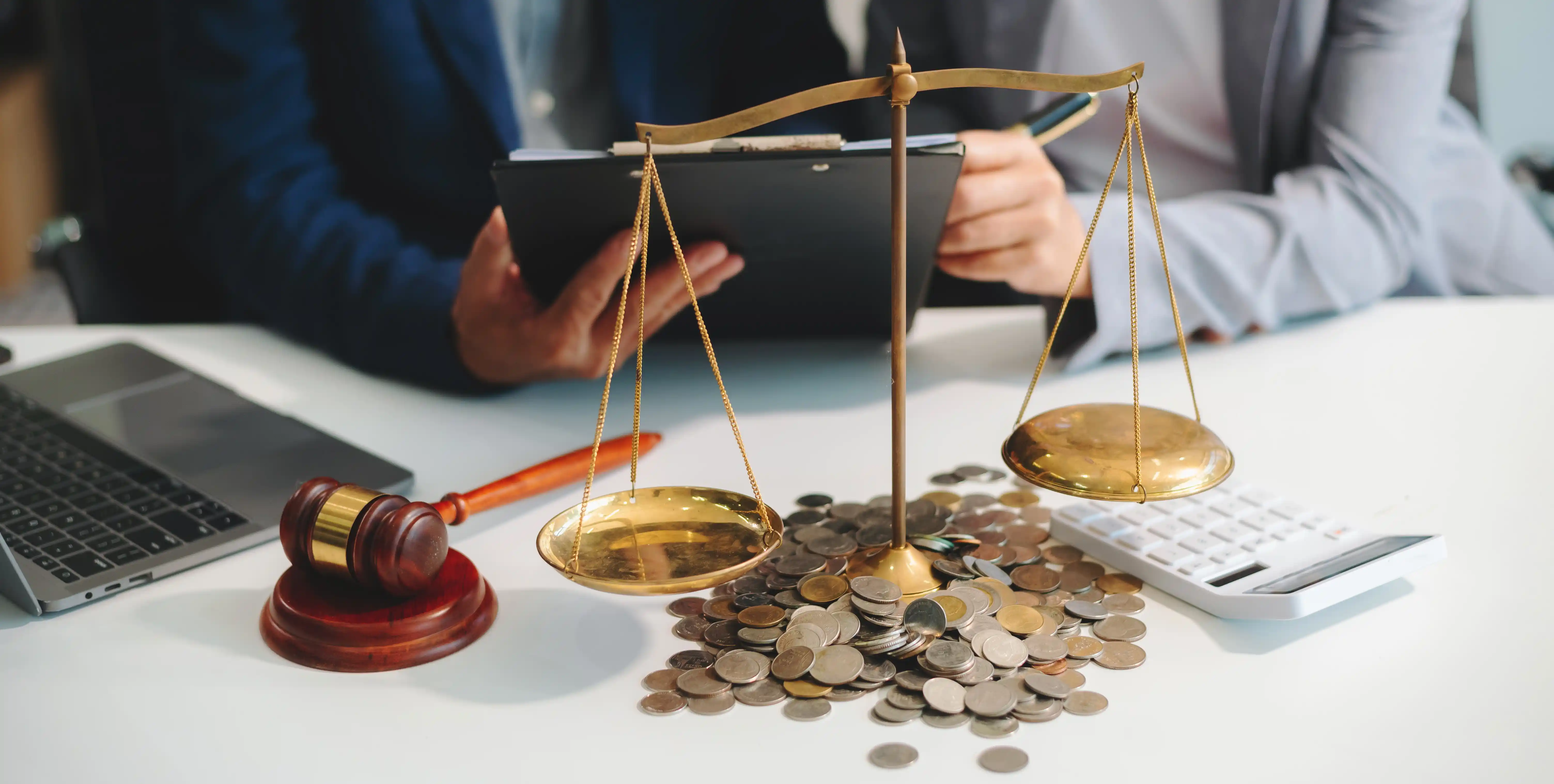 Lawyer with brass scales coins and gavel representing legal compliance and ethical culture in finance and law teams