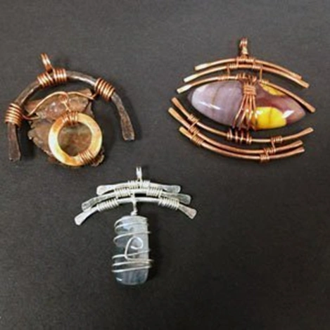 three wire wrapped pendants with stones