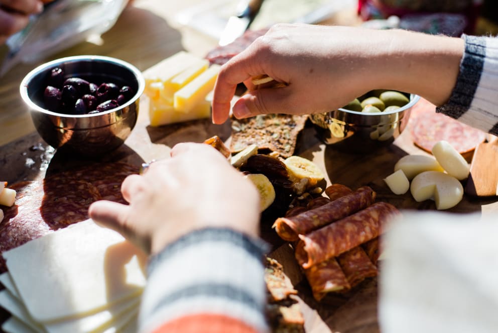 woman making charcuterie board