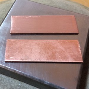 Copper pieces on a steel bench block