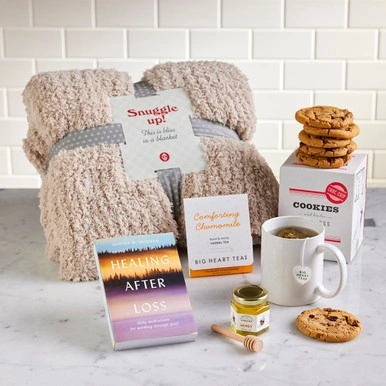 A warm blanket, "Healing after Loss" Book, Honey, tea and cookies 