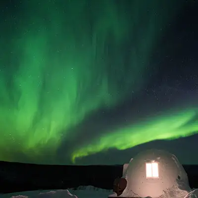 Igloo under the northern lights.