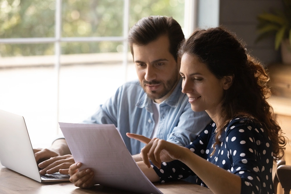 happy couple looking at paperwork together