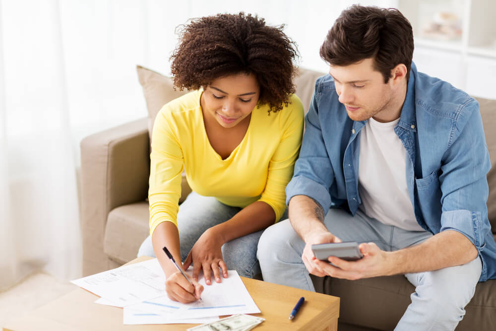 Couple working on budget with title loan