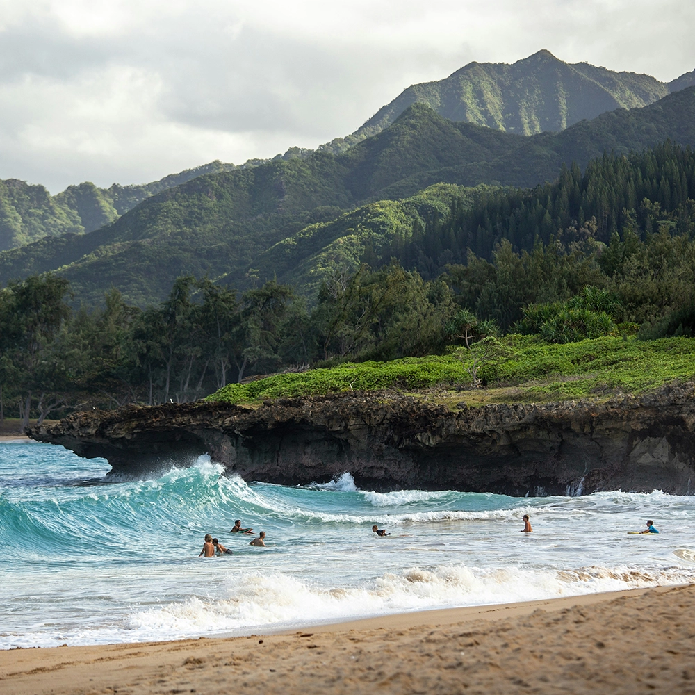 Northern beaches of Hawaii with mountain background.