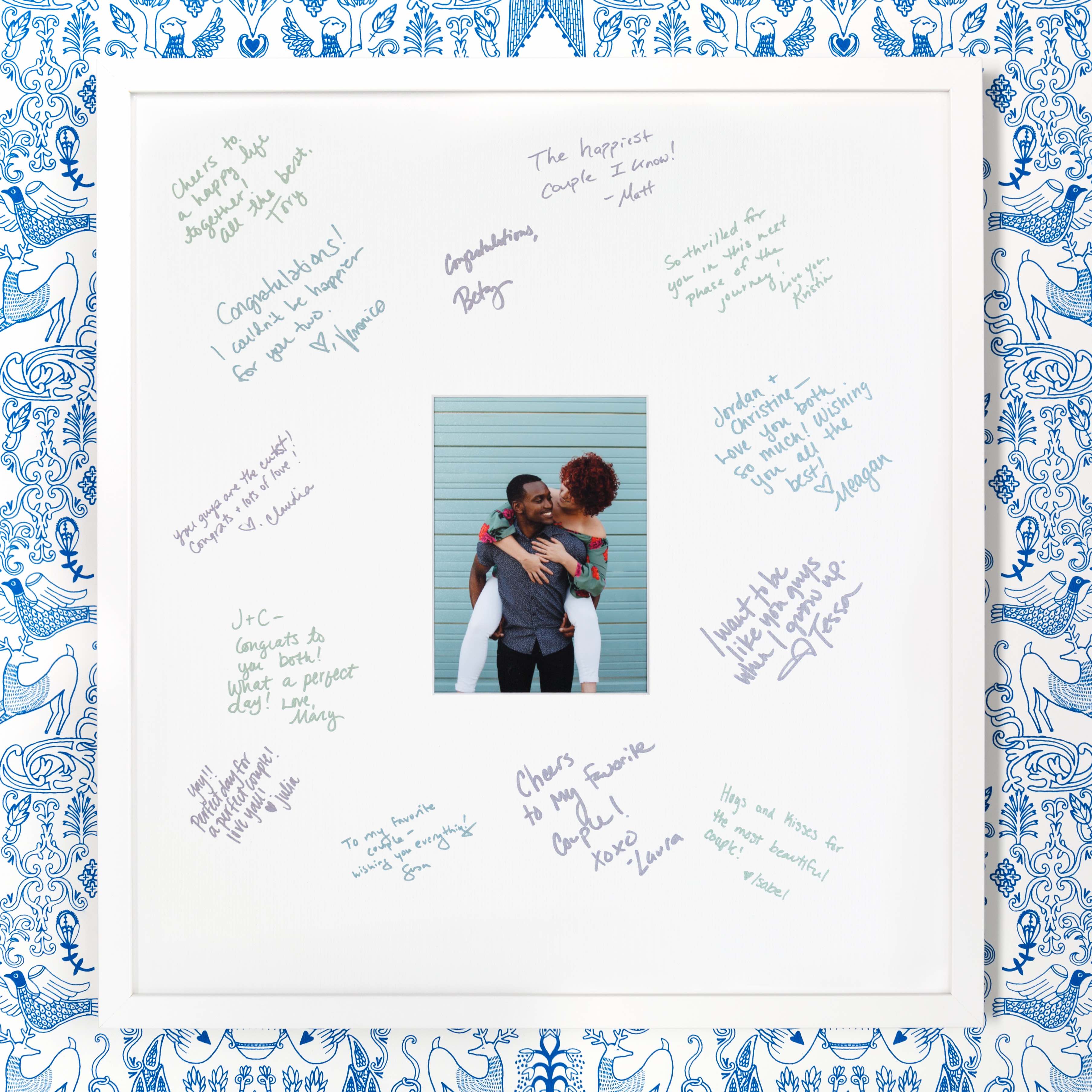 a framed and matted engagement photo with well wishes and autographs on the mat