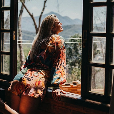 Woman looking out window.