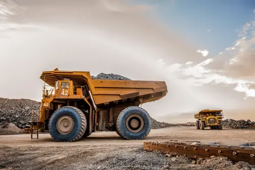 Construction workers using a haul truck on a job site