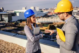 Two workers discuss productivity on the job site
