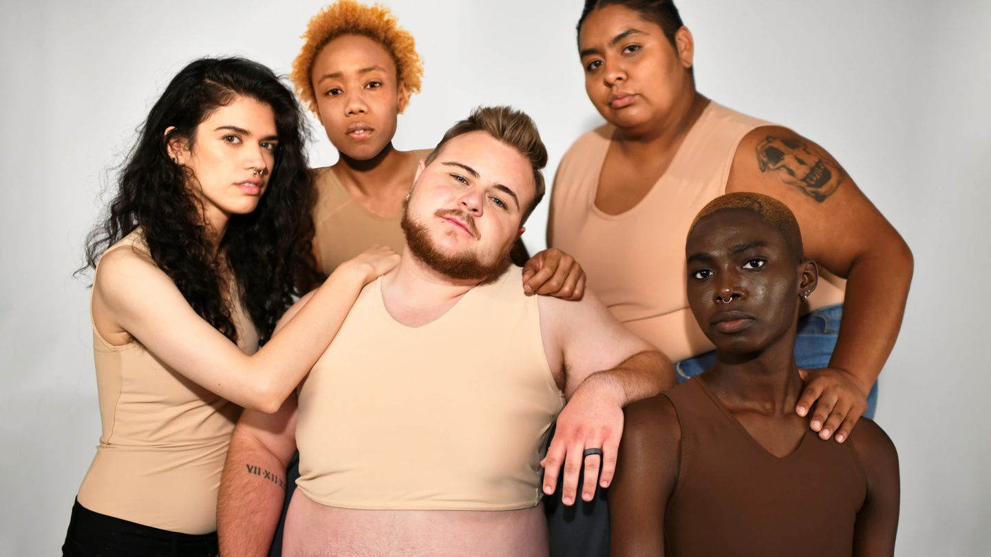 A group of five people of different races and body types dressed in different GC2B binder styles pose together.