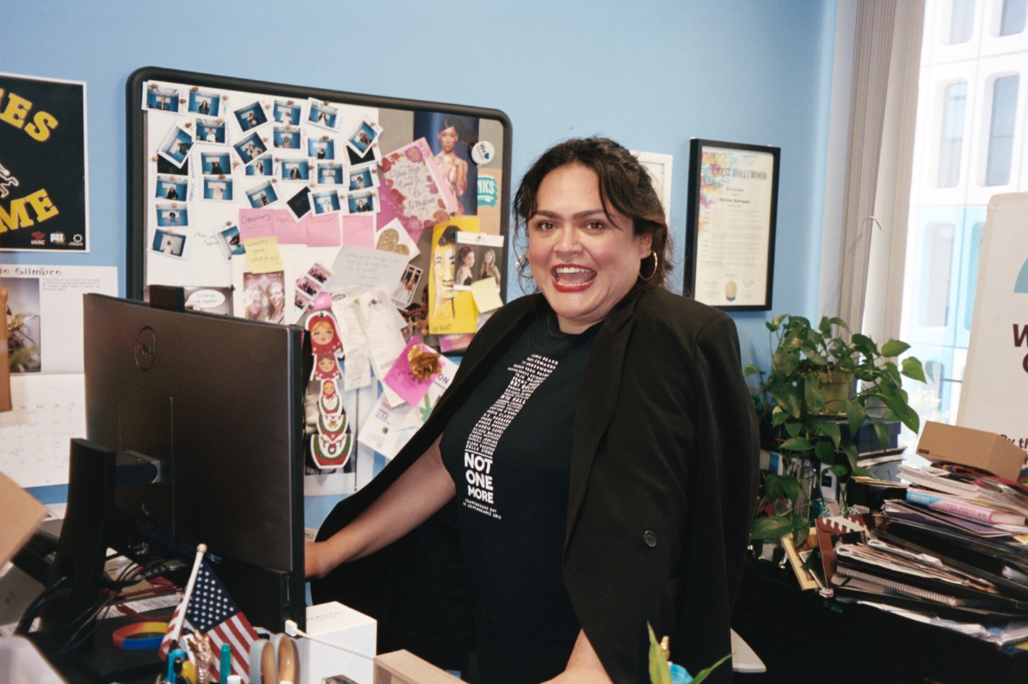 Mariana Marroquin, program manager of the Transgender Wellness Center (TWC) standing at her desk.