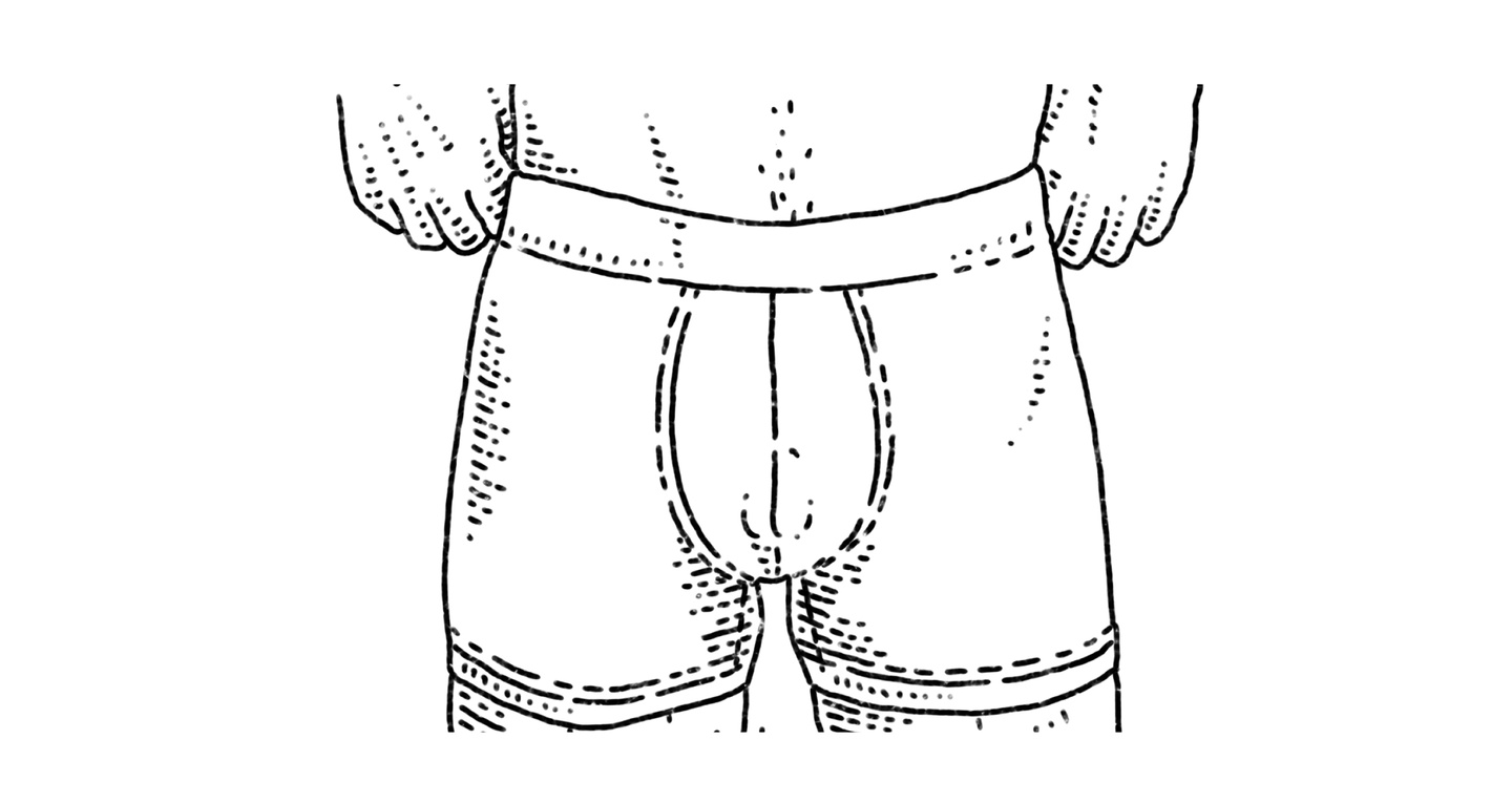 an ftm transgender person standing with boxer briefs and their bottom growth showing 