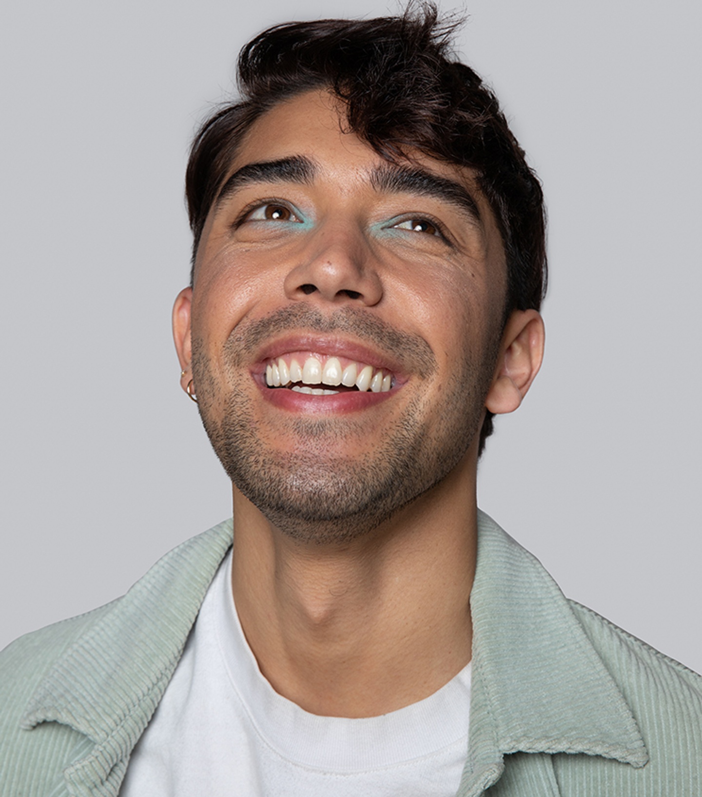 Person smiling in front of a gray background