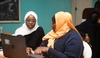 Hadija Hamisi speaking with a colleague