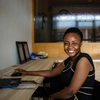 A woman sitting at a desk with a computer.