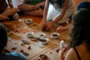 IYR National Gathering, Whitehorse, July 2025, a group gathered cutting meat to eat.