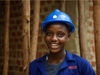 A young person wearing overalls and a hard hat.