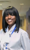 Women in Doctors clothing smiling at camera