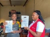 Vanessa Ishimwe and co-worker showcasing her business logo on a printed bag