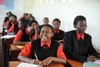 A classroom of students working in matching uniforms.