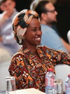 Smiling woman dressed in colourful clothing.