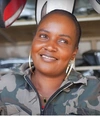 Rosa Wambui Mendi smiling in her Auto spares shop in Nairobi, Kenya