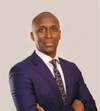 Ivan Ntwali standing in a smart blue suit