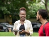 A young lady holding a plate and speaking to another participant from the North American Mastercard Foundation Alumni Network, at their summer social in 2025.