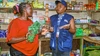 Two women having a discussion at a food shop in Kenya 2025