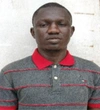 Ousmane Kama wearing a grey and red stripe shirt with a red collar