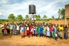 Gordon Victor with a group of people in front of a water tower