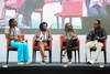 A group of young people speaking on a panel on a stage