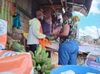 Eric serving one of his regular customers at his Green Grocery Kiosk in Kangemi, Nairobi