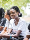 A young student sitting with classmates.