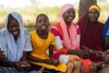 A group of young women sitting together and smiling.
