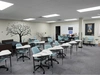 A classroom with two rows of seats with individual desks at Gabriel Dumont Institute, 2025.